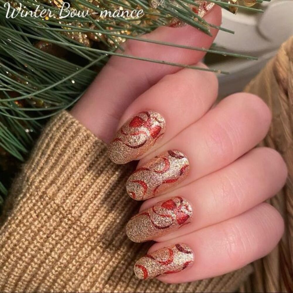 Color Street - Winter Bow-mance, a glittery gold with dark red bows